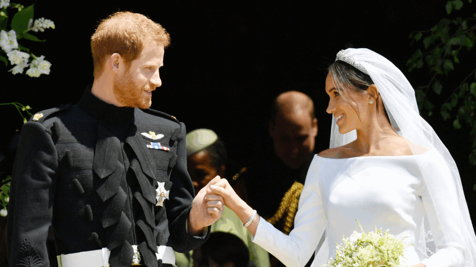 Prince Harry wears military uniform and Meghan Markle wears a white wedding dress by Givenchy at their royal wedding on May 19, 2018
