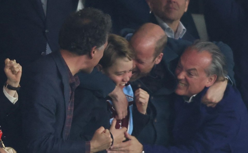 Prince William and Prince George celebrating a goal at a soccer match.