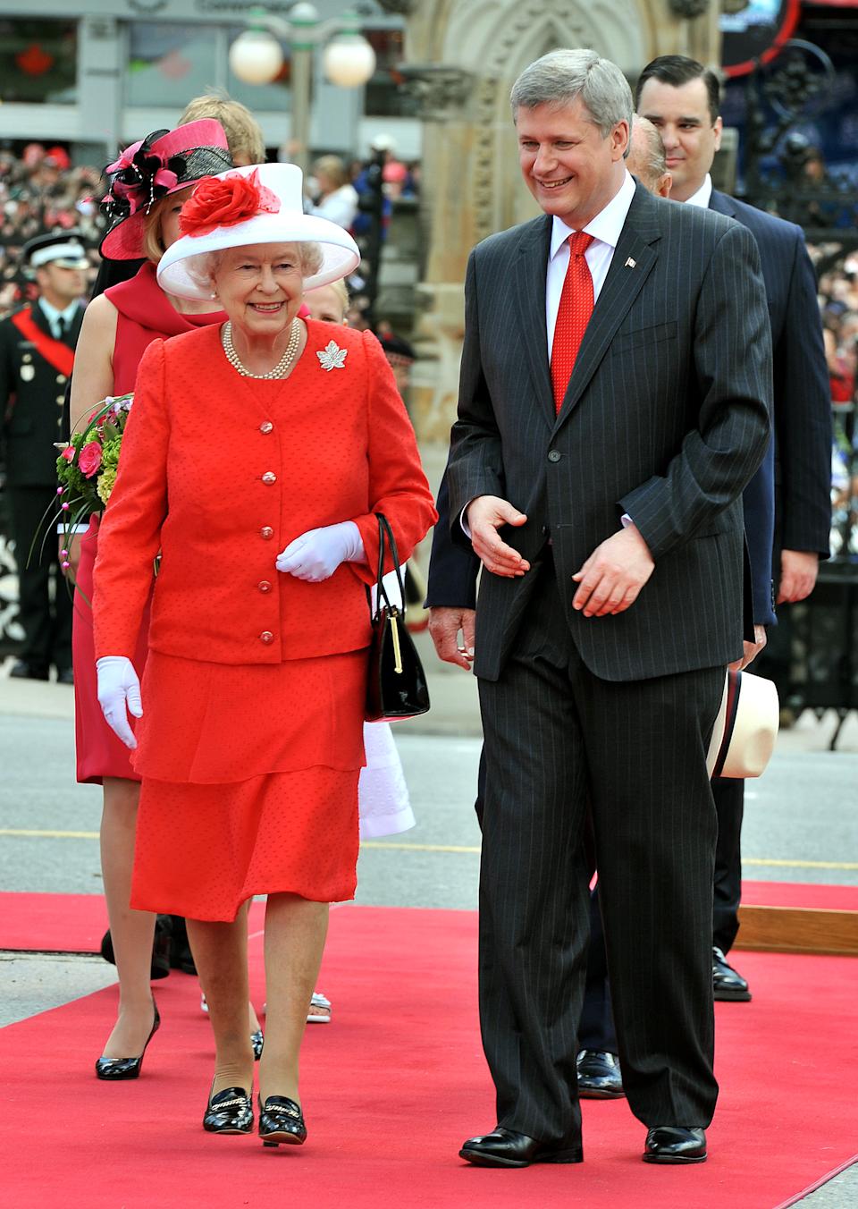 OTTAWA, ON - JULY 01: Queen Elizabeth II with Stephen Harper the Prime Minister of Canada outside the Parliament Building after arriving to attend the Canada Day celebrations on July 1, 2010 in Ottawa, Canada. The Queen and Duke of Edinburgh are on an eight day tour of Canada starting in Halifax and finishing in Toronto. The trip is to celebrate the centenary of the Canadian Navy and to mark Canada Day. On July 6th the Royal couple will make their way to New York where the Queen will address the UN and visit Ground Zero. (Photo by John Stillwell-Pool/Getty Images)