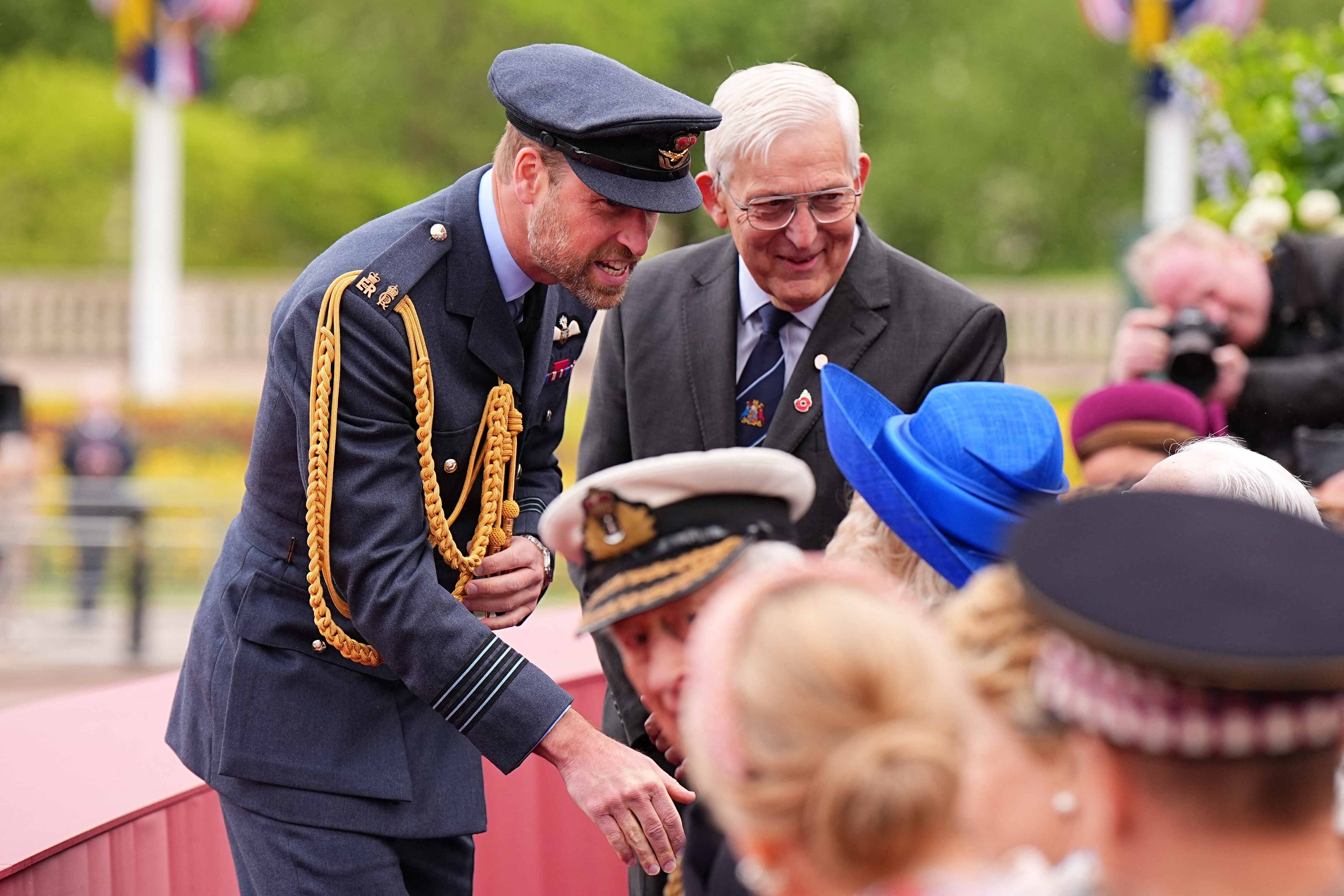 Prince William greets Queen Camilla and King Charles.