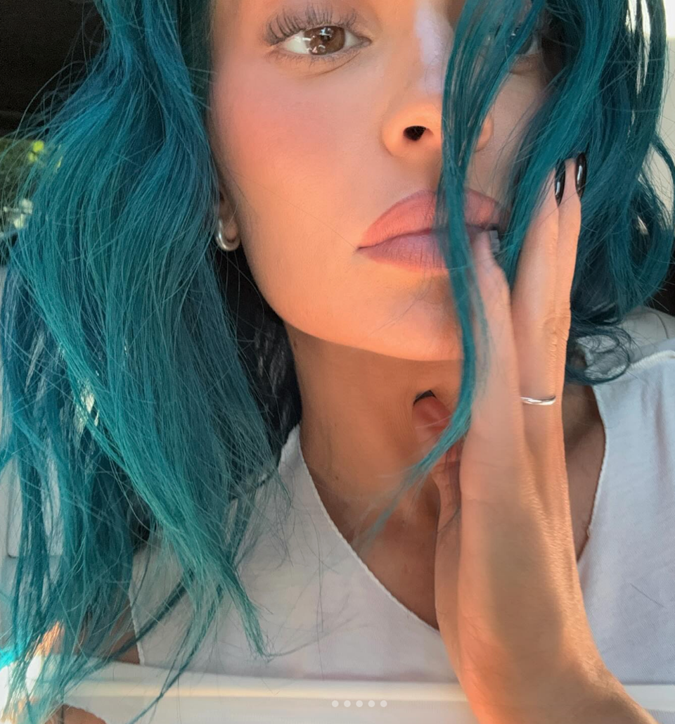 Kylie Jenner with loose hair and a thoughtful expression