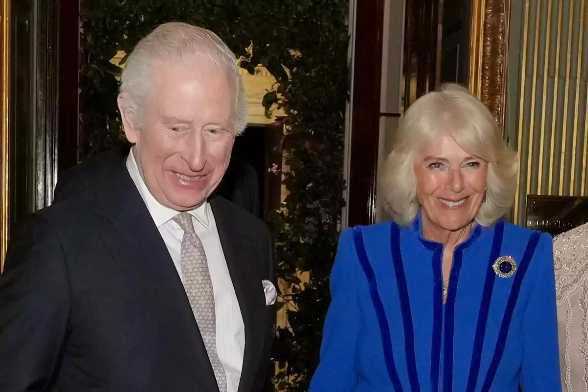 King Charles III and Queen Camilla smile as they pose together at a formal event. King Charles III and Queen Camilla smile as they pose together at a formal event.