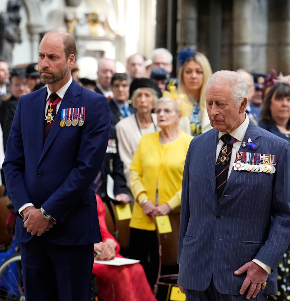  Prince William and King Charles wearing blue suits with medals standing next to each other. 