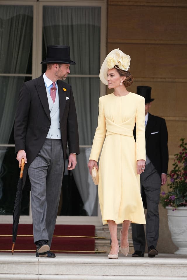 The Prince and Princess of Wales look at one another as they prepared to make their way onto the lawn