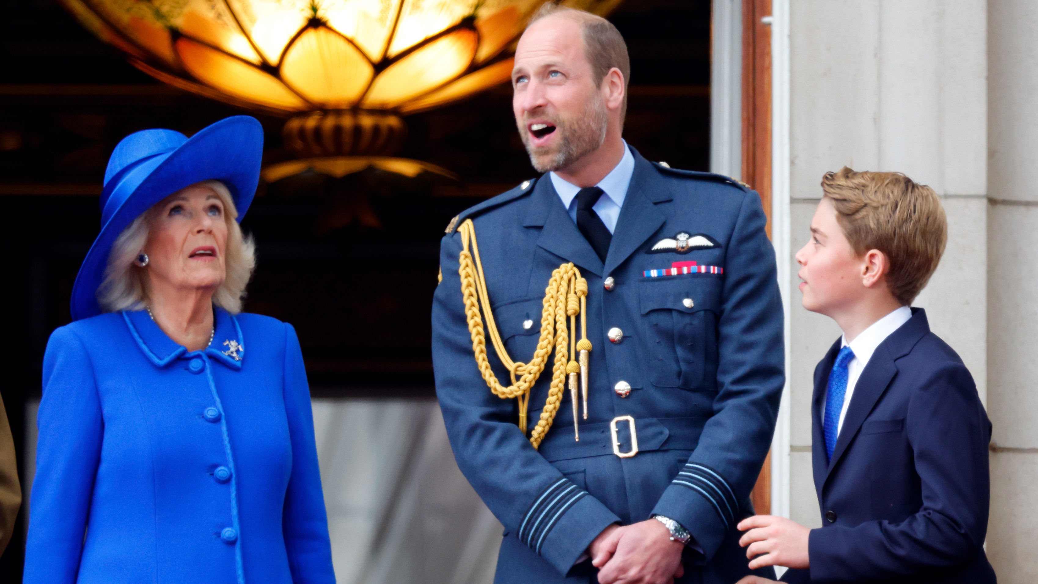 Queen Camilla, Prince William and Prince George of Wales watch a flypast from the balcony of Buckingham Palace to mark the 80th anniversary of VE Day on May 5, 2025