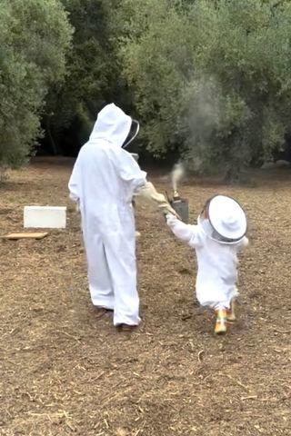 Meghan, Duchess of Sussex/Instagram Meghan Markle and Princess Lilibet in beekeeper suits