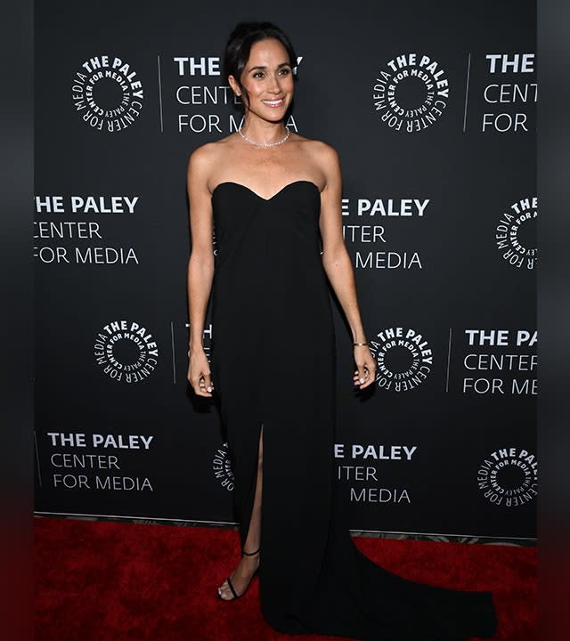 Meghan Markle wearing a sleeveless glamorous black gown.