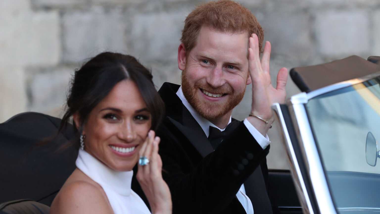 Prince Harry and Meghan Markle’s Wedding Photographer Reveals Unseen Photo—and How He Wrangled the Royal Kids Prince Harry and Meghan Markle waving while driving to their wedding reception in a convertible