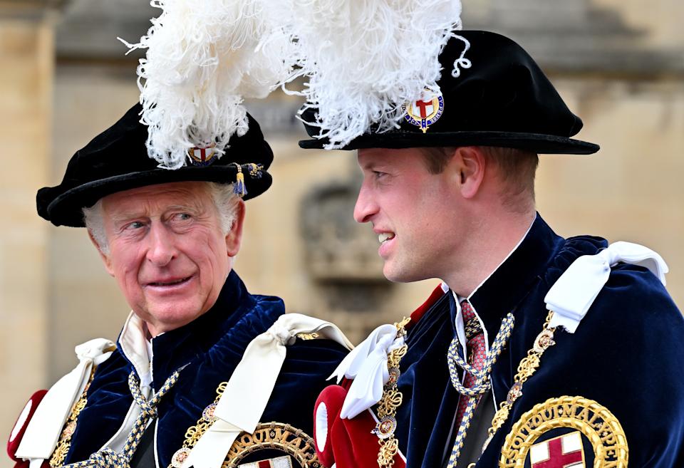 King Charles and Prince William wearing feathered hats and velvet robes at Garter Day