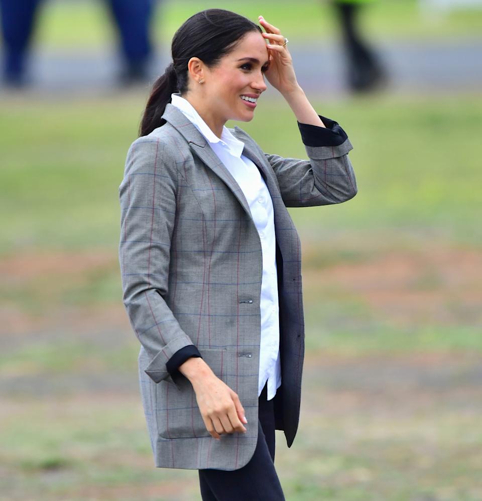  Meghan Markle wearing a gray blazer and black jeans in 2018. 