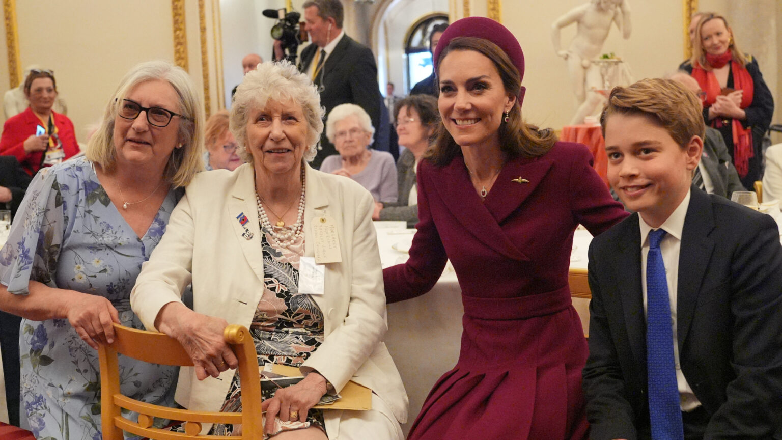 Prince William and Princess Kate are “Careful Not to Overwhelm” Prince George as They Prepare Him to be King Prince George posing with his mom Kate Middleton and two women at a tea party