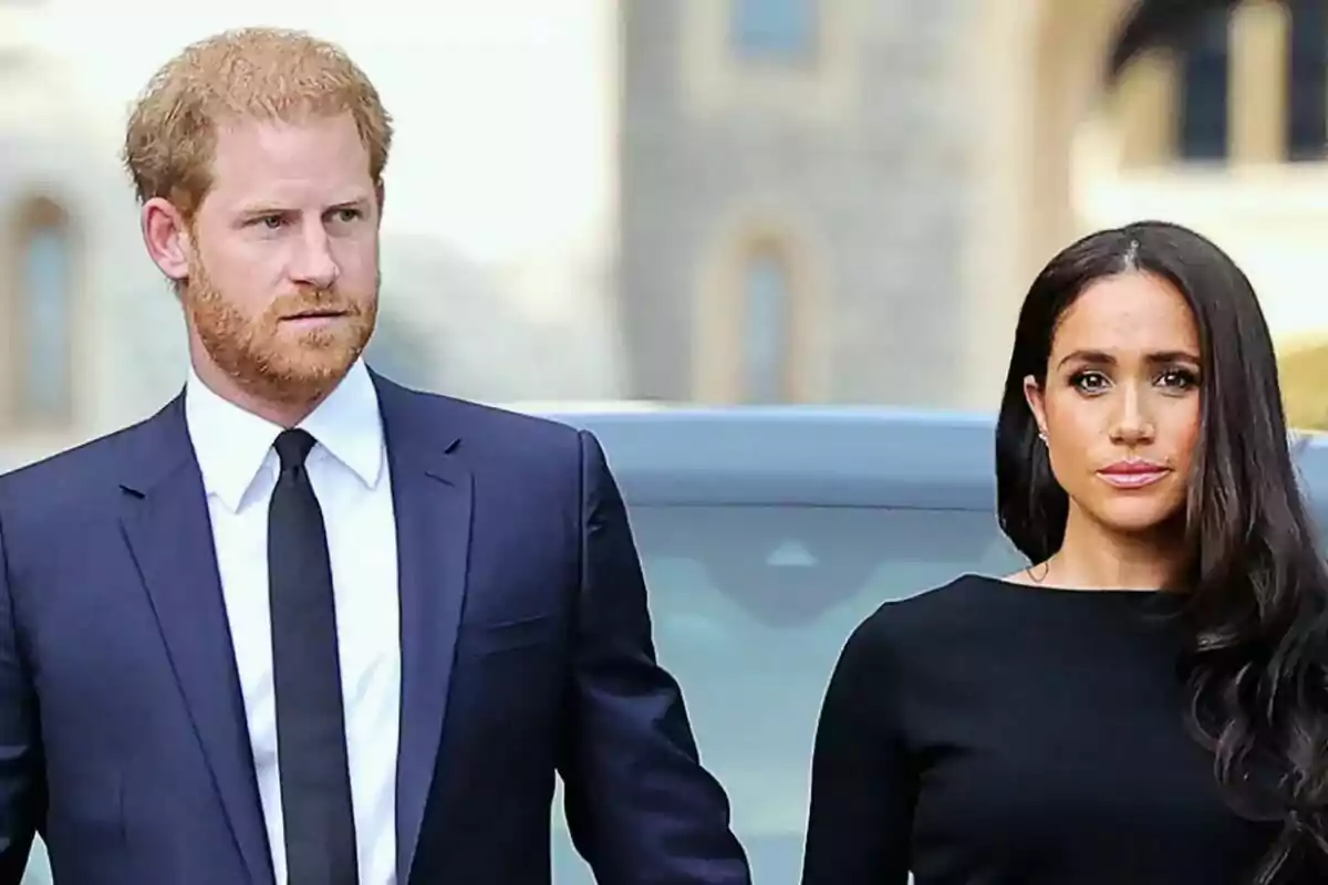 Two people dressed formally walking together outdoors.