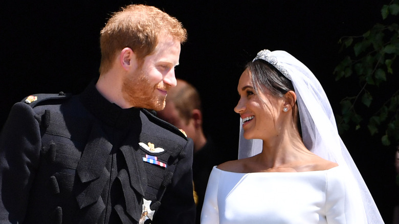 Prince Harry smiling at Meghan Markle during their wedding