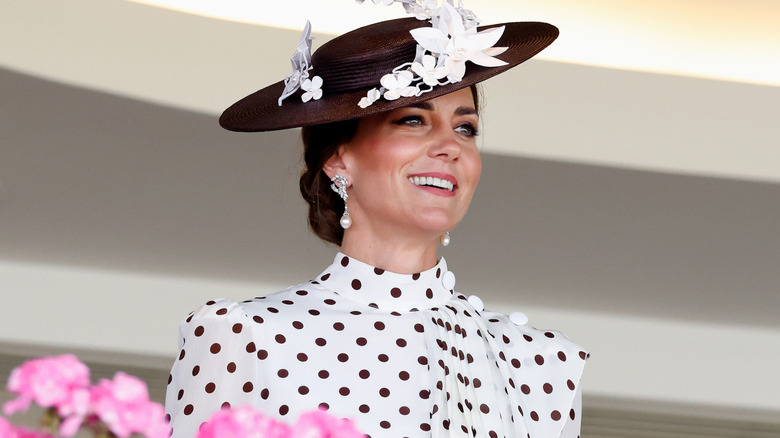 Princess Catherine in a white dress with black polka dots and black hat with veil