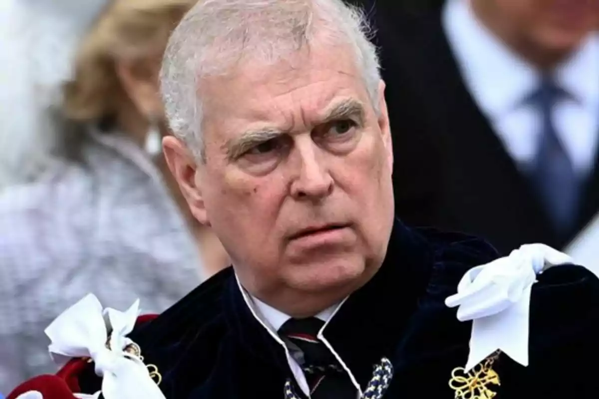 Prince Andrew with grey hair and a serious expression, dressed in a formal suit adorned with ribbons and medals. Prince Andrew with grey hair and a serious expression, dressed in a formal suit adorned with ribbons and medals.