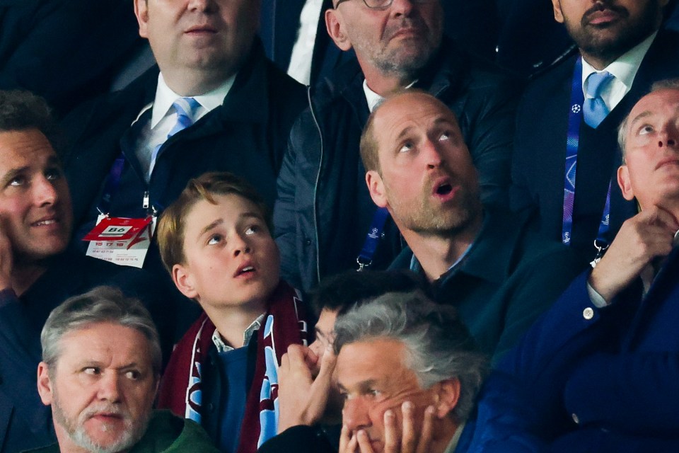 Prince George and Prince William watching a soccer match.