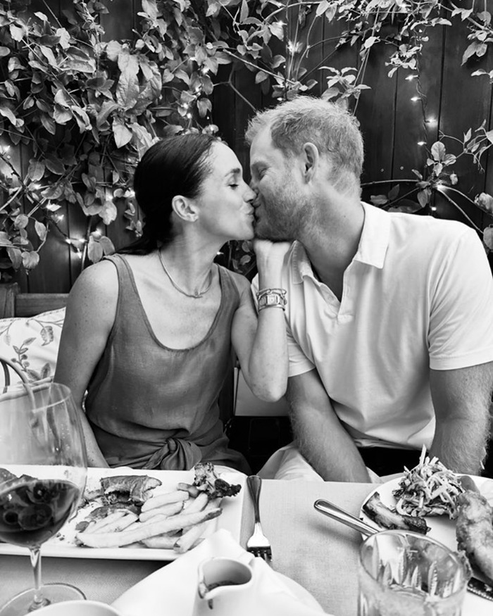 Prince Harry and Meghan sharing a kiss at dinner, hidden symbols on Prince Harry’s cowboy hat sparking buzz.