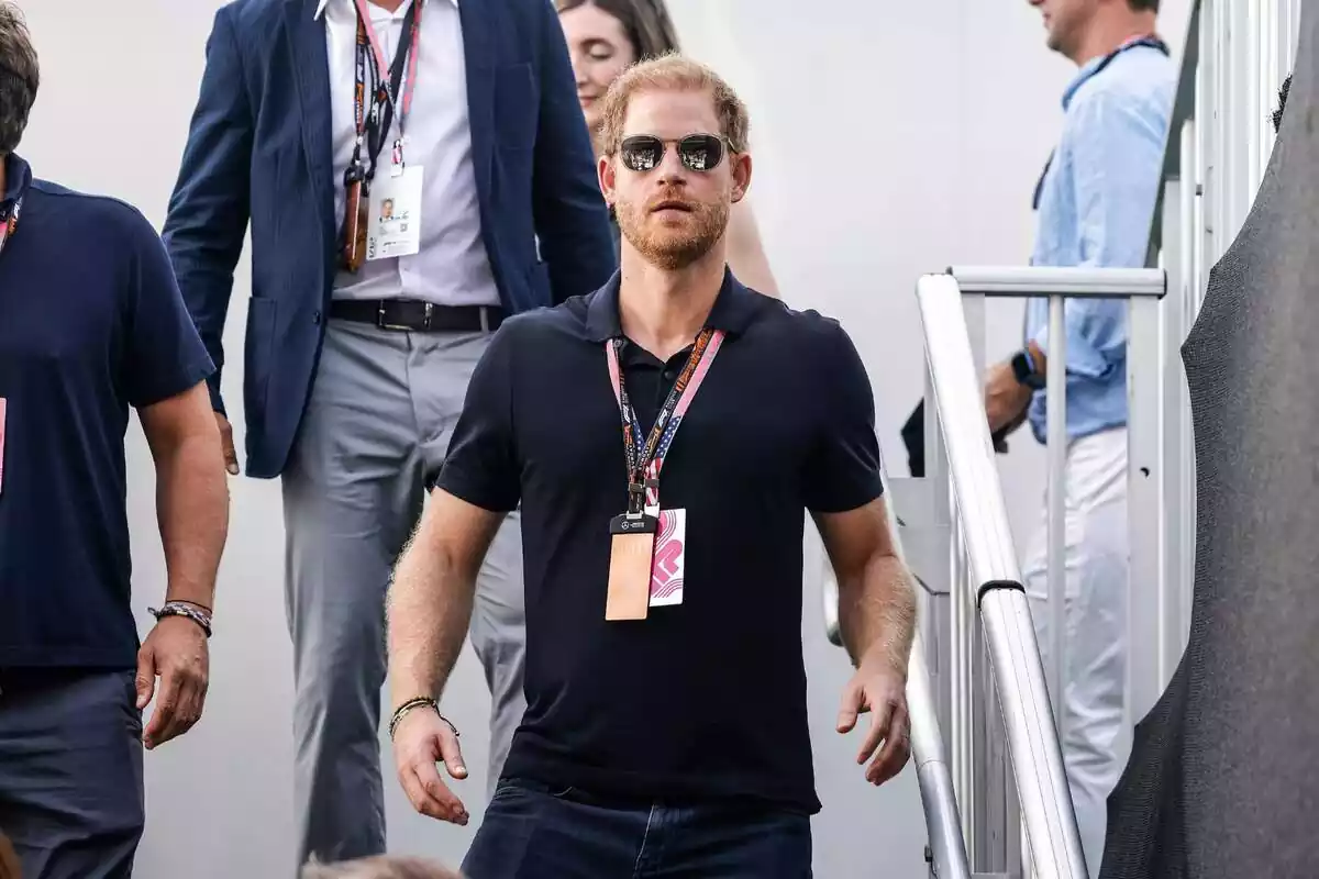 Prince Harry wearing sunglasses walking down stairs Prince Harry wearing sunglasses walking down stairs