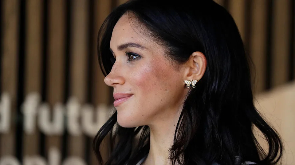 A close-up of Meghan Markle with the word "future" behind her.