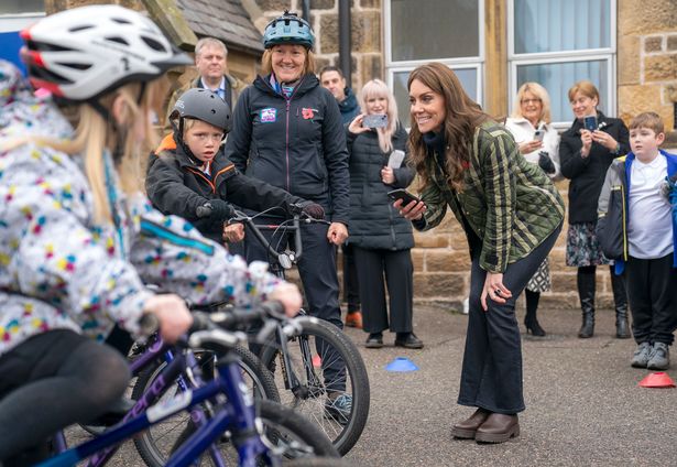 Princess Kate times a bike race for school kids