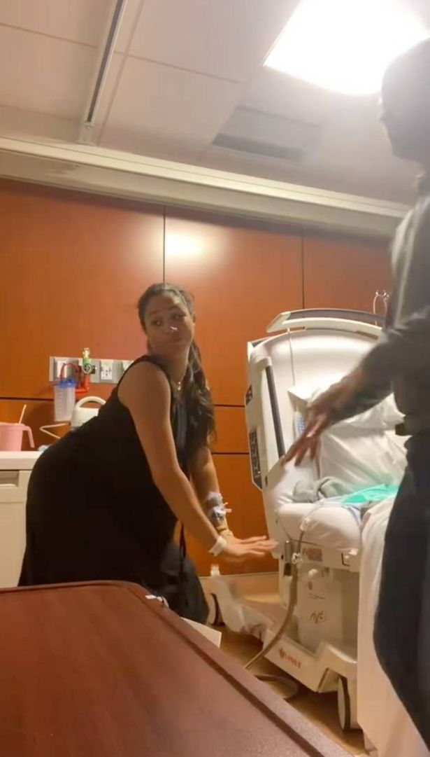 Meghan in a black dress twerking in a hospital delivery room