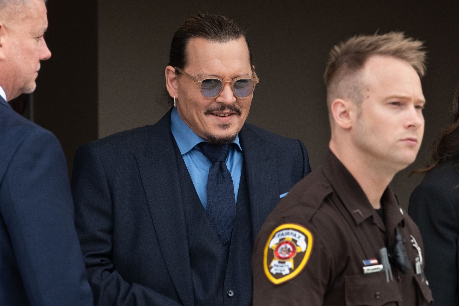 Image may contain Johnny Depp Accessories Glasses Formal Wear Tie Adult Person People Officer and Police Officer