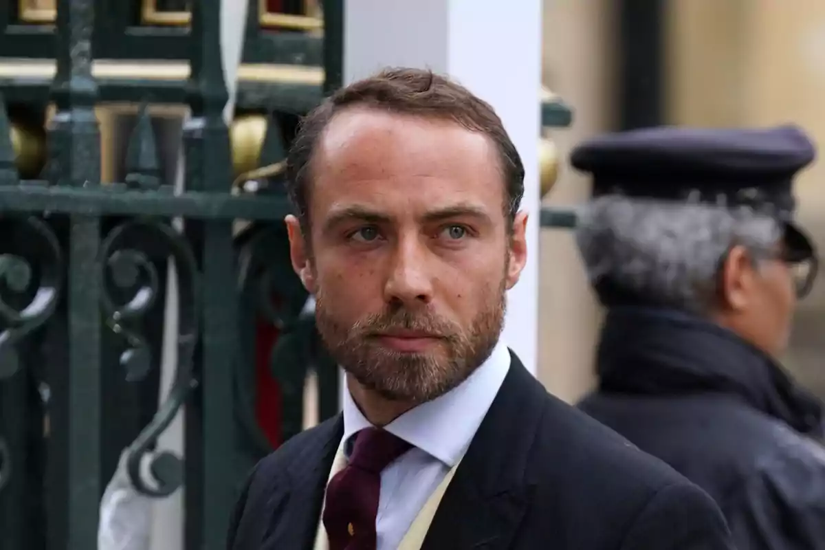 James Middleton in a formal suit and tie in an urban setting