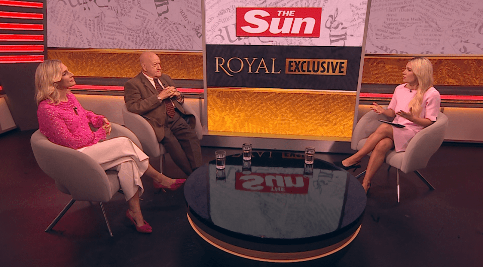 Three people seated on a television show set discussing a royal exclusive.