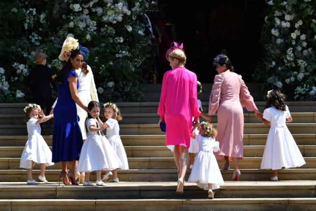 Catherine, Duchess of Cambridge (2ndL) and Jessica Mulroney (L) hold bridesmaids hands as they arrive for the wedding ceremony of Prince Harry and US actress Meghan Markle at St George's Chapel, Windsor Castle on May 19, 2018 in Windsor, England. (Photo by Ben Stansall - WPA Pool/Getty Images)