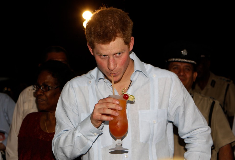Prince Harry drinking a rum punch at a street party in Belize.