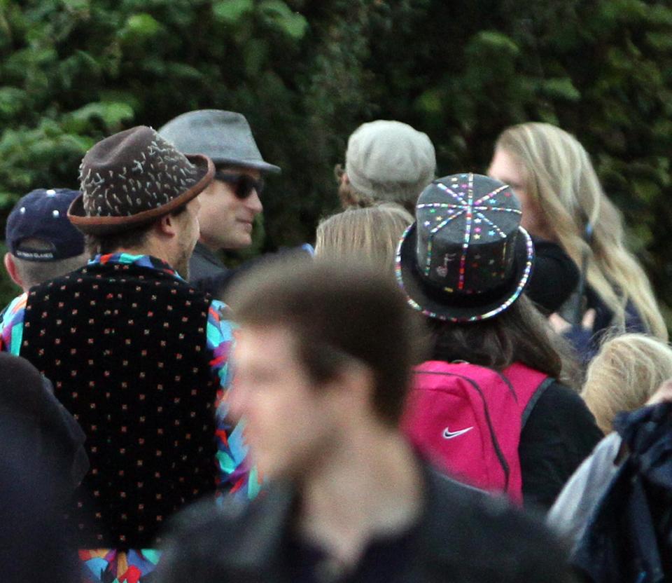 Crowd of people wearing hats at a music festival.