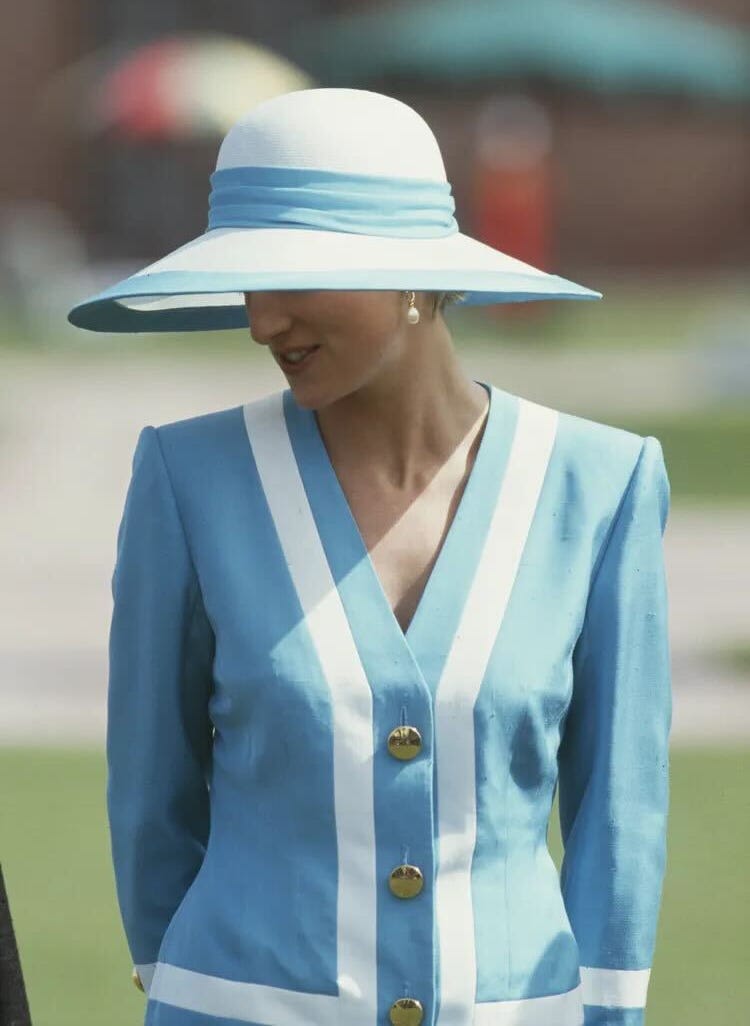 a person wearing a blue outfit with white stripes and a large sunhat a person wearing a blue outfit with white stripes and a large sunhat