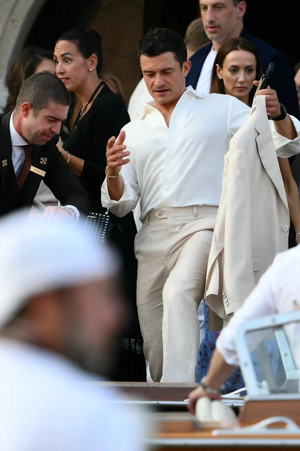 Orlando Bloom, who is reportedly fresh from his split with Katy Perry, was spotted getting on a taxi boat to Thursday’s welcome party. He wore a wide-collared button-down shirt, paired with a cream linen blazer and pants. Bloom was one of the few guests who understood the Italian summer wedding assignment. (AFP via Getty Images)