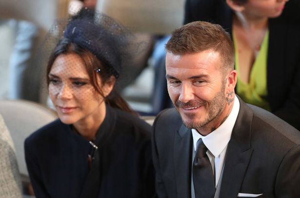 David and Victoria Beckham take their seats in St George's Chapel before the wedding ceremony of Britain's Prince Harry, Duke of Sussex and US actress Meghan Markle in St George's Chapel, Windsor Castle, in Windsor, on May 19, 2018.