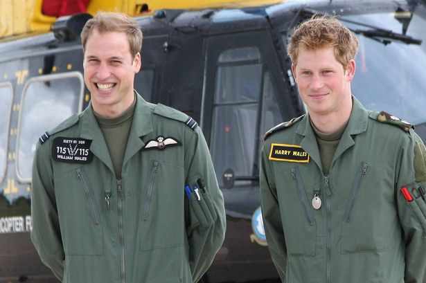 TRH Prince William and Prince Harry pose in front of a Griffin helicopter during a photocall at RAF Shawbury on June 18, 2009 in Shawbury, England