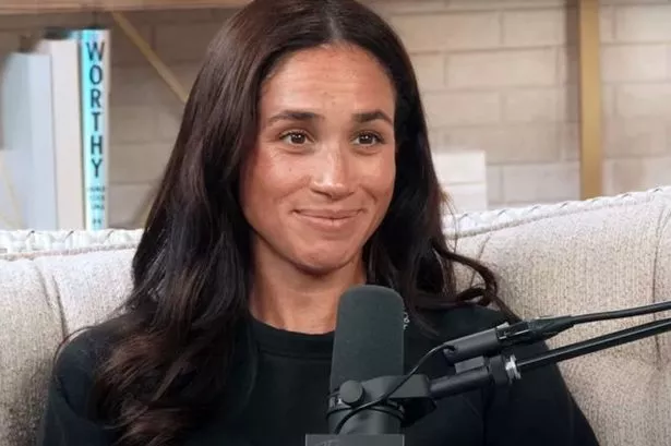 Meghan Markle on a podcast wearing a black t-shirt and bare faced with no makeup on