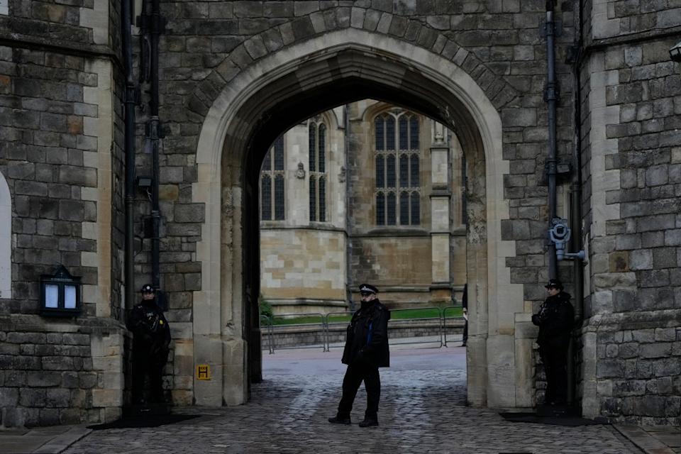 Police guard the Henry VIII gate at Windsor Castle at Windsor, England on Christmas Day, Saturday, Dec. 25, 2021. Britain’s Queen Elizabeth II has stayed at Windsor Castle instead of spending Christmas at her Sandringham estate due to the ongoing COVID-19 pandemic. (AP Photo/Alastair Grant)
