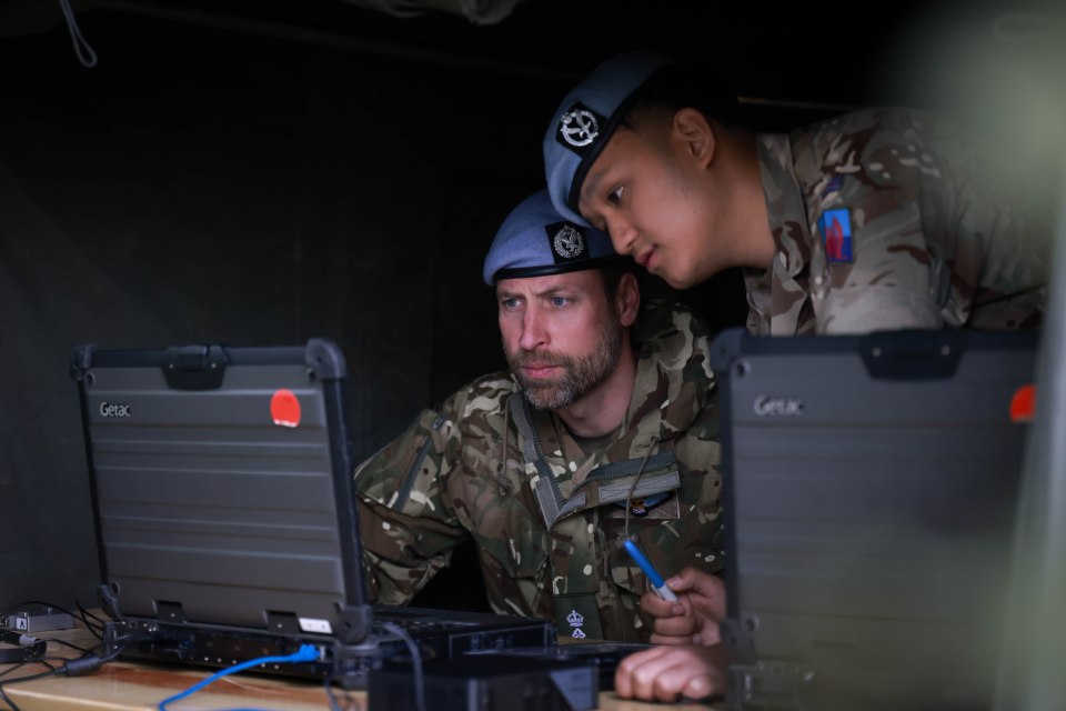 The Prince of Wales reviewing operational data with Army Air Corps personnel.