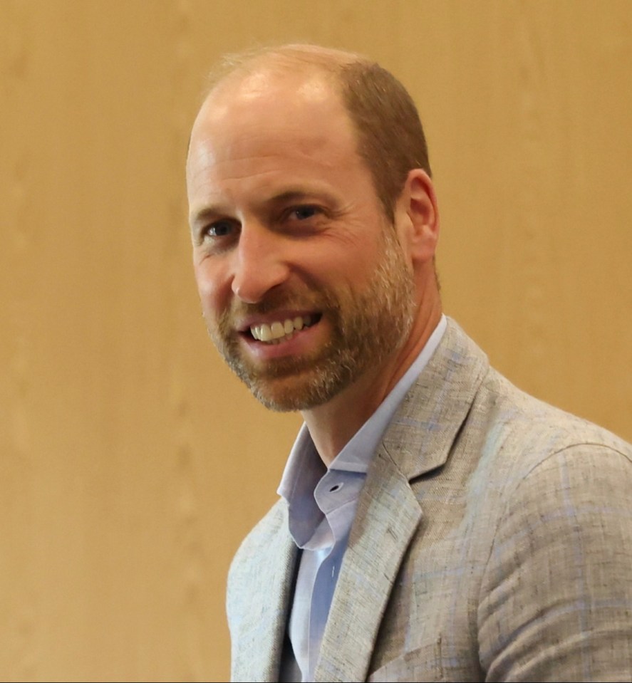 Prince William presenting a jersey to a member of the England Women's football team.