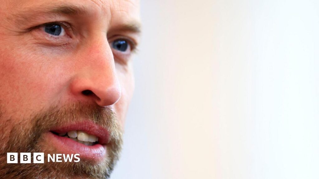 Prince William unveils plan to restore Dartmoor A close-up of Prince William's face. He looks like he is concentrating on something as his eyes are focussed. He has a brown and grey-flecked beard and moustache and blue eyes.