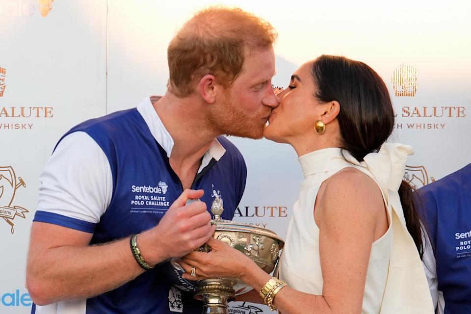 Prince Harry and Meghan Markle share a kiss after a charity polo match.