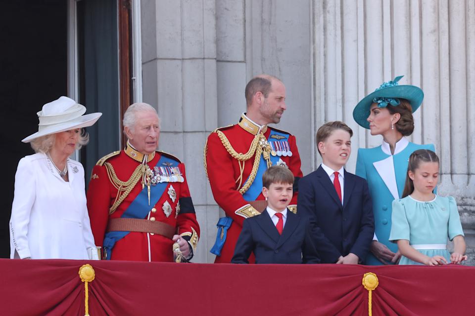 Kate Middleton and Prince William talking on the Buckingham Palace balcony at Trooping the Colour