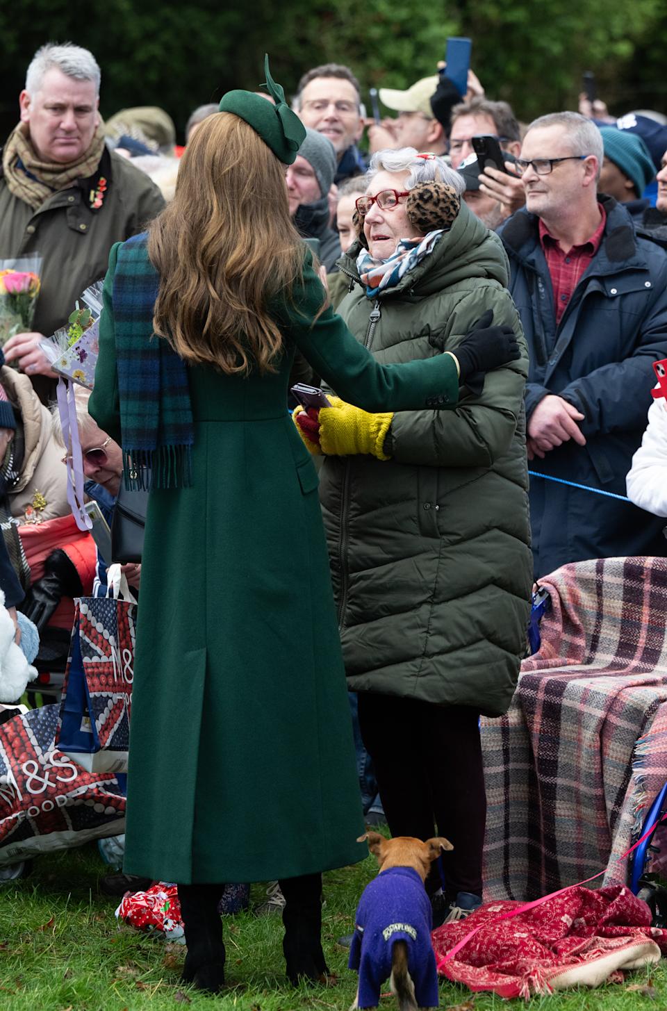 Kate Middleton hugging a fan on Christmas Day in a green coat