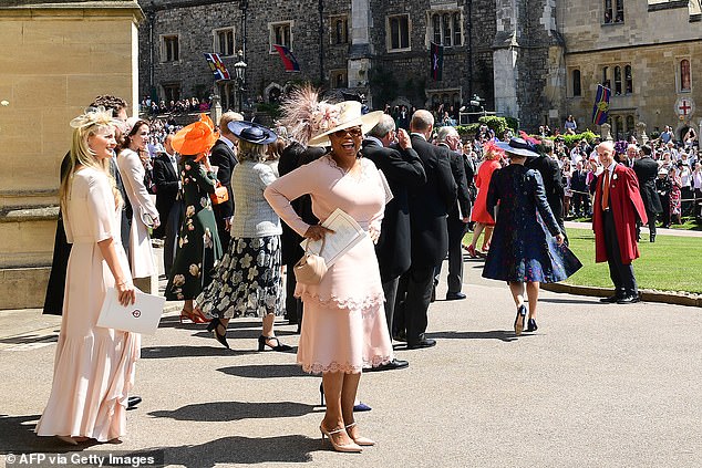 Oprah leaving the wedding ceremony. According to author Tina Brown, the star had 'scarcely met' Meghan before the big day