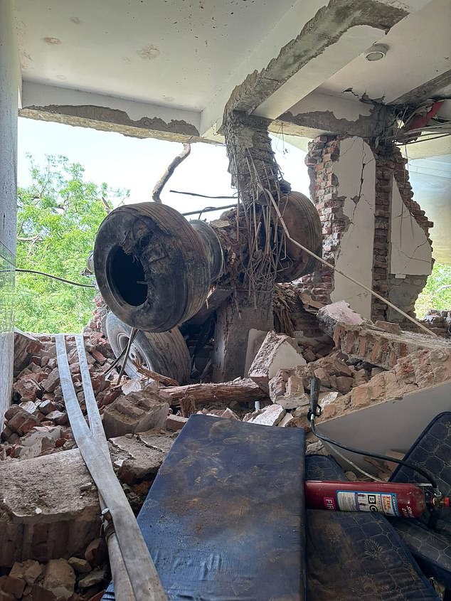 Remnants of the fuselage and the landing gear were seen dangling through a gaping hole in the side of what appeared to be a canteen, with half-finished plates of food clearly visible on benches inside