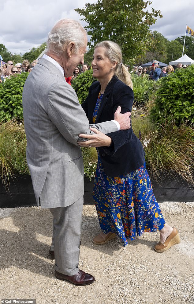The King quickly responded to prevent any further embarrassment, catching Sophie's arms to steady her as she struggled with the curtsey