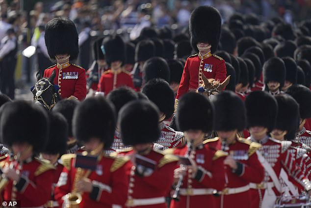 Officers of the Grenadier Guards mounted on horses ride along the Mall as they take part in the Trooping the Color in London