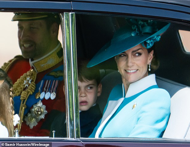 William and Kate smile at those gathered along the Mall as they arrived at Buckingham Palace for the Trooping the Colour