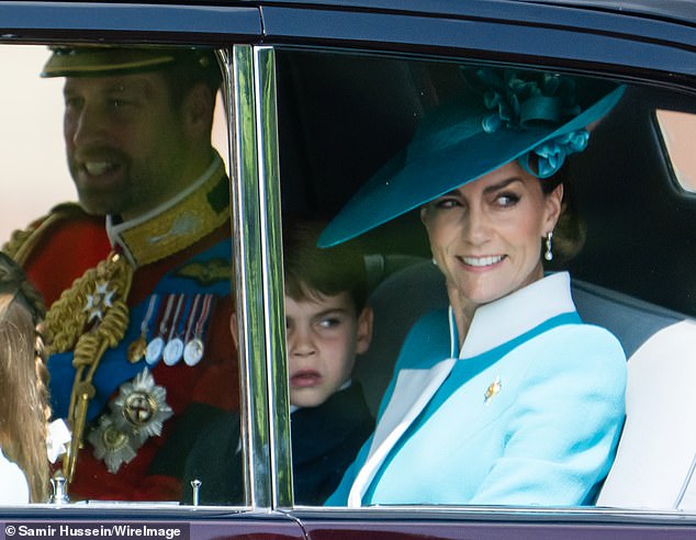 William and Kate smile at those gathered along the Mall as they arrived at Buckingham Palace for the Trooping the Colour