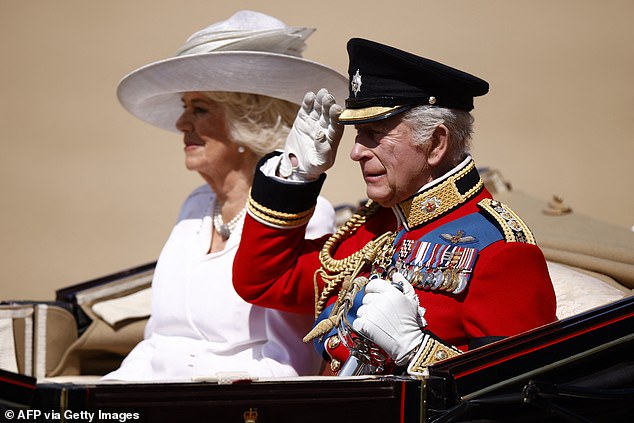 King Charles III salutes next to Britain's Queen Camilla as they arrive to Horse Guards Parade for the King's Birthday Parade